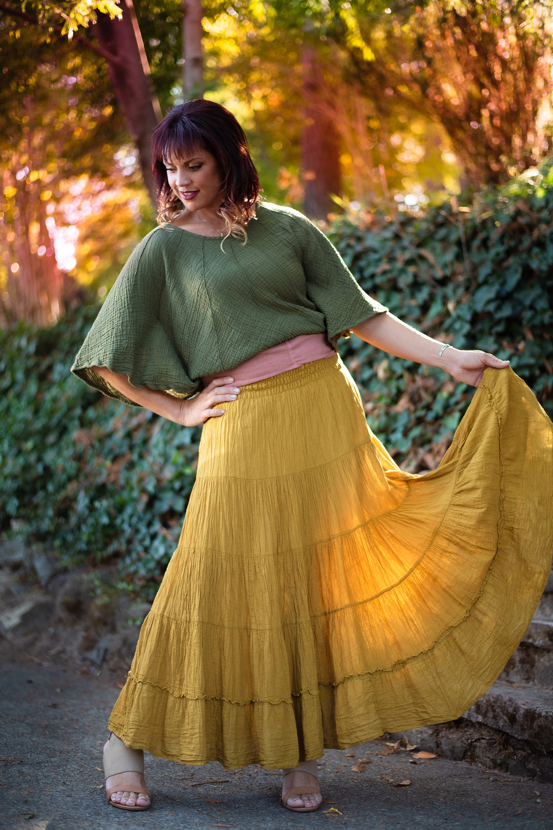 Woman wearing a gold tiered maxi skirt