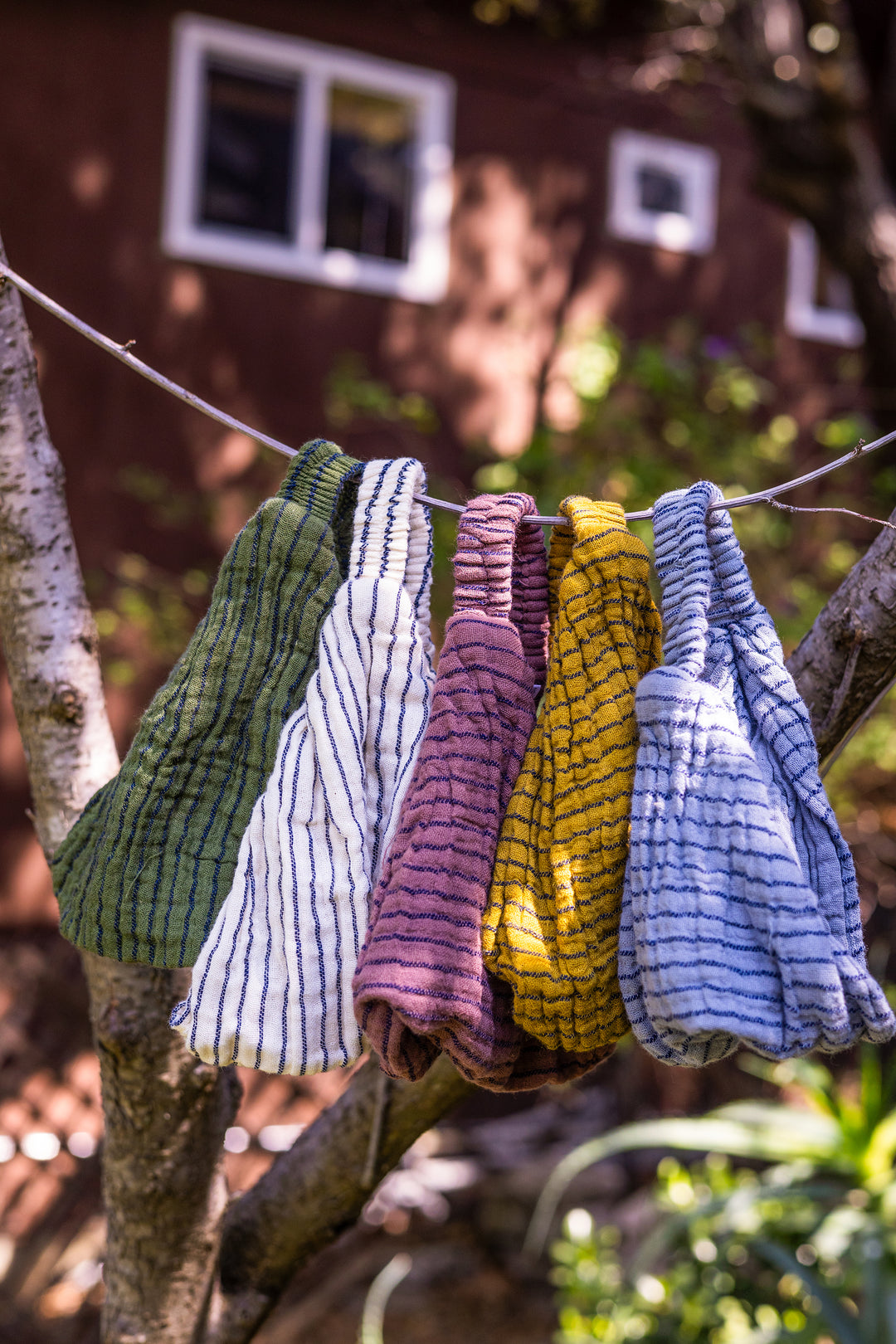 Headbands of various colors hang from clothesline.