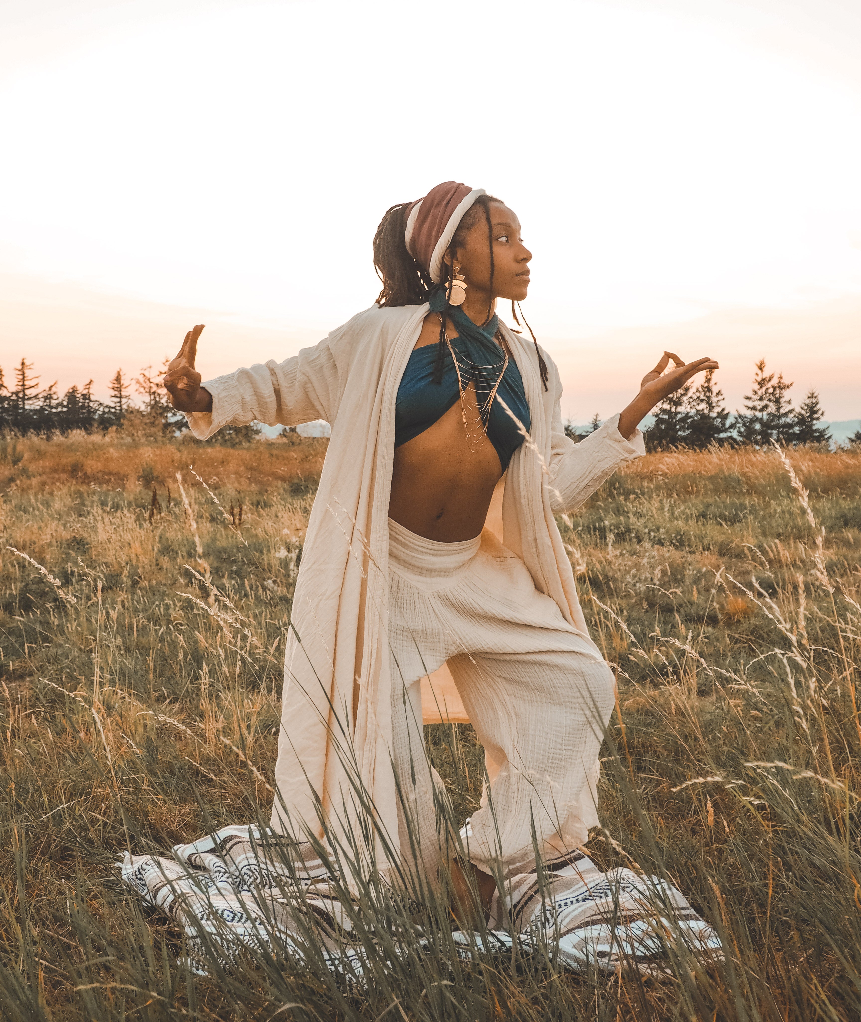 Model wears gauze cloak over yoga clothing.