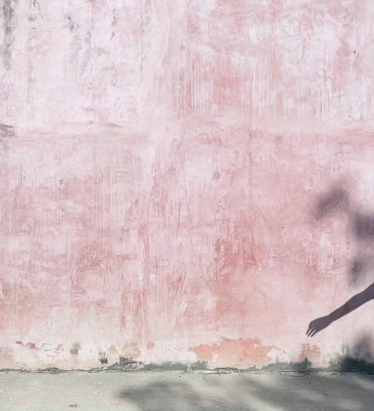 Dancer does a split jump wearing soft, flowy clothing.